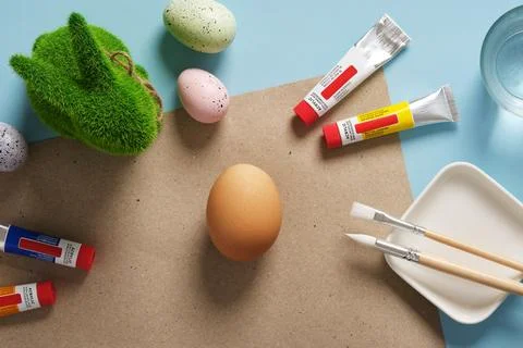 Preparation for Easter celebration. Painting Easter eggs with acrylic pigment Stock Photos