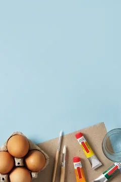 Preparation for Easter celebration. Painting Easter eggs with acrylic pigment Stock Photos