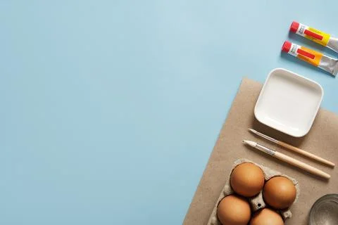 Preparation for Easter celebration. Painting Easter eggs with acrylic pigment Stock Photos