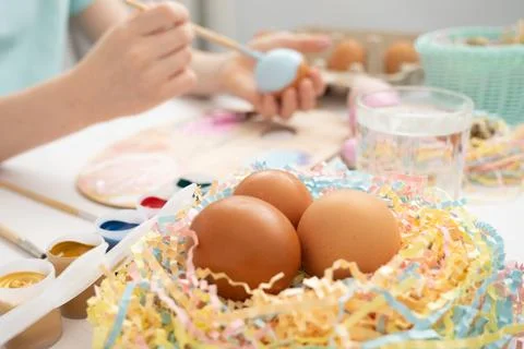 Preparation for Easter. The child is holding a large egg in his hands. Pastel Stock Photos
