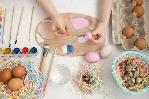 Preparation for Easter. The child is holding a large egg in his hands. Pastel Stock Photos