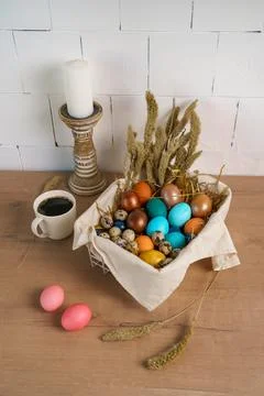 Preparation for Easter holiday. colored chicken eggs lie in deep bowl on table Stock Photos