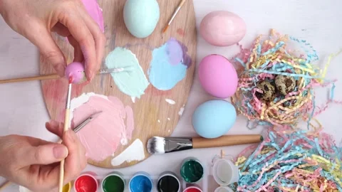 Preparation for Easter. View from above. Women's hands paint a quail egg in a Stock Footage 171833258