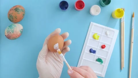 Preparation for Easter, women's hands dye eggs, close-up view from above Stock Footage 171003663