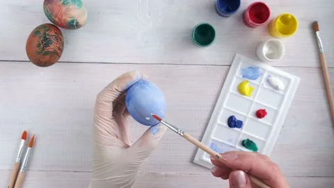 Preparation for Easter, women's hands dye eggs, close-up view from above Stock Footage 172103564