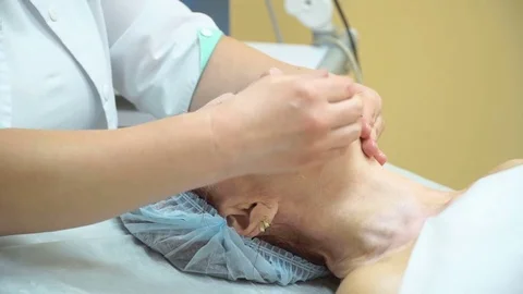 Preparation of an elderly woman for RF procedure lifting in a cosmetology clinic Stock Footage 74769953