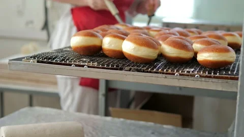 Preparation of fresh fried doughnuts with stuffing at the production factory Stock Footage 171890852