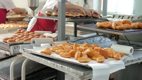 Preparation of fresh fried doughnuts with stuffing at the production factory Stock Footage 171891253