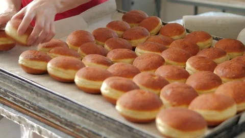 Preparation of fresh fried doughnuts with stuffing at the production factory Stock Footage 171891319