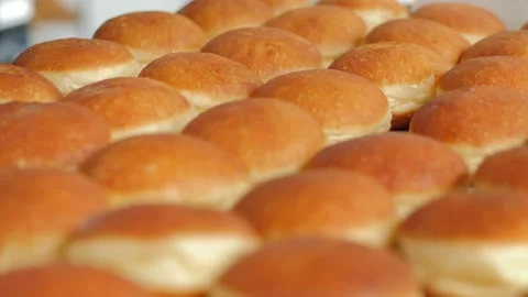 Preparation of fresh fried doughnuts with stuffing at the production factory Stock Footage 171893034