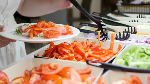 Preparation of Fresh Salad at a Buffet for Guests and Diners Stock Footage 316524070