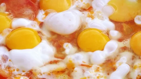 Preparation of the fried eggs with tomatoes in UHD Stock Footage 114726688