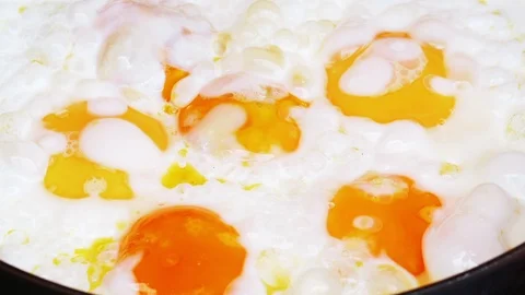 Preparation of the fried eggs in UHD Stock Footage 112540737