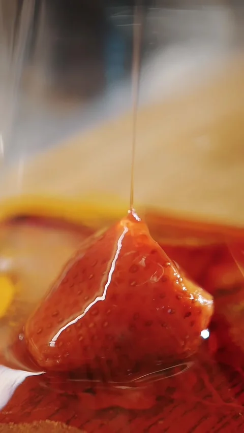 Preparation of fruit tea. tea drink. making tea. close-up. one fresh strawberry Stock Footage 323513553