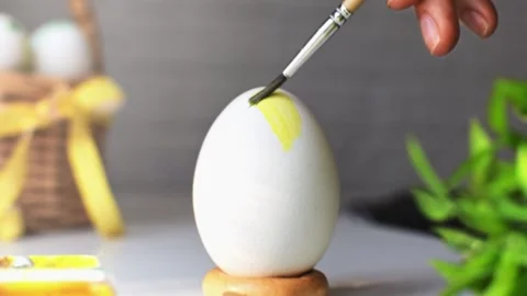 Preparation for Happy Easter spring holiday. Closeup painting the chicken egg. Stock Footage 236476706