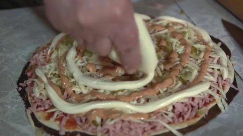 Preparation of homemade pizza on a light kitchen table, close-up shot. Stock Footage 75031952