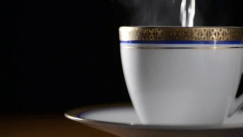 Preparation of a hot tea on a black background Stock Footage 90716525