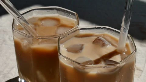 Preparation of iced latte, stirring  Of cold Iced Coffee with. Stock Footage 156936334