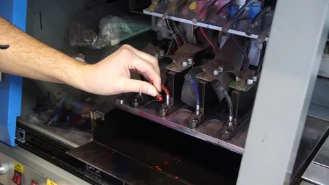 Preparation for the large-format inkjet printing press. Male hands worker merge Stock-Footage 99525261