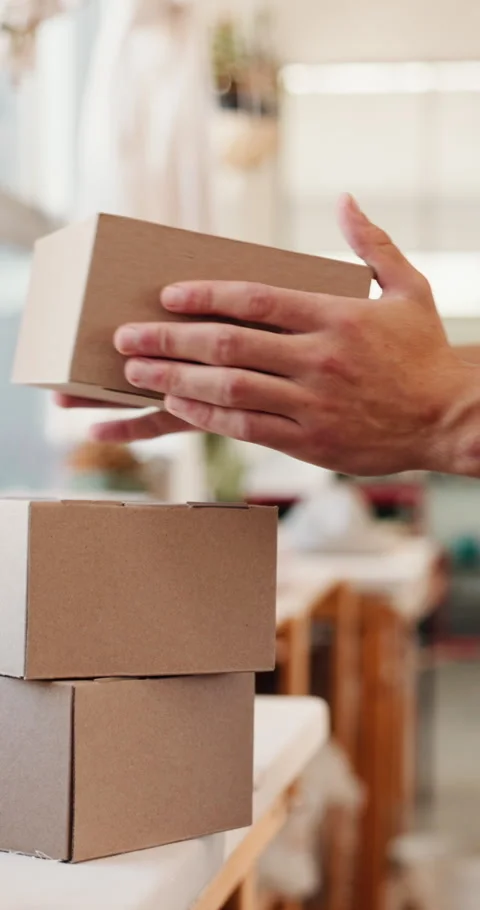 Preparation, logistics or man in creative studio with box, package sorting or Stock Footage 333608242