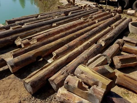 Preparation of logs for the construction of an eco-house. Stock Photos