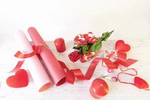 Preparation of materials for the packaging of a romantic gift, paper, ribbons Stock Photos