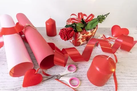 Preparation of materials for the packaging of a romantic gift, paper, ribbons Stock Photos