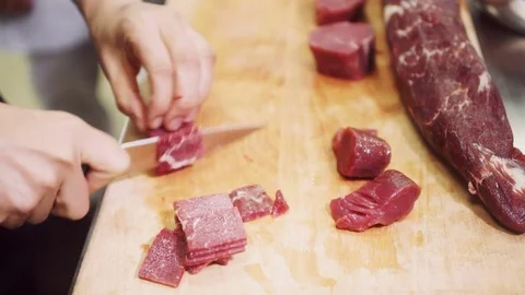 Preparation meat cutting for cooking in kitchen at restaurant Stock Footage 71516037