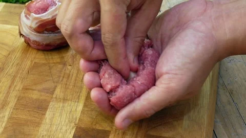 Preparation of meatballs stuffed with cheese and covered with bacon Video stock 242088694