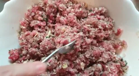 Preparation of minced meat for dolma: meat, herbs, butter, onions interfere with Stock Footage 131546232
