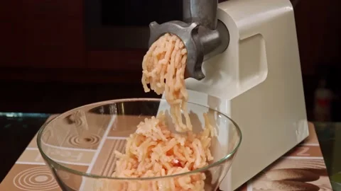 Preparation of minced meat in an electric ground beef grinder from fresh meat. Stock Footage 169459697