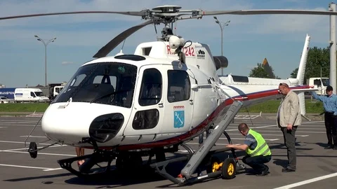 Preparation of multi-purpose helicopter Eurocopter AS350 for towing Stock Footage 106799654
