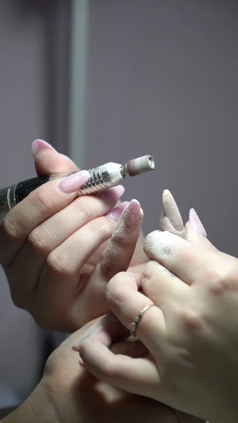 Preparation of nails with a manicure machine for manicure, vertical shot 스톡 동영상 330469601