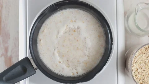 Preparation oatmeal with milk Video stock 88798654