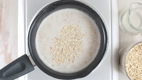 Preparation oatmeal with milk Video stock 88798658