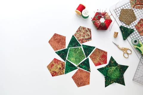 Preparation of pentagon and triangular pieces of fabric for sewing patchwor.. Stock Photos