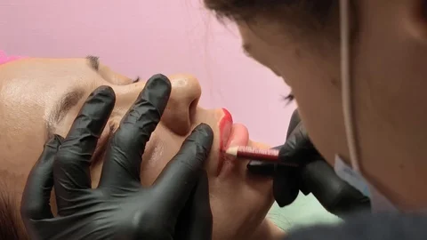 Preparation for permanent makeup. Draws a contour with a red pencil. Cosmetology Video stock 119892136