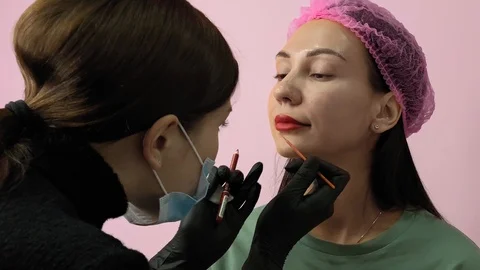 Preparation for permanent makeup. Draws a contour with a red pencil. Cosmetology Video stock 119892153