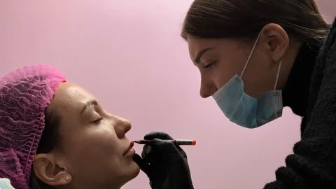 Preparation for permanent makeup. Draws a contour with a red pencil. Cosmetology Video stock 119892314