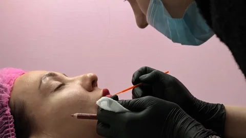 Preparation for permanent makeup. Draws a contour with a red pencil. Cosmetology Video stock 119892414