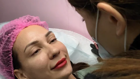 Preparation for permanent makeup. Draws a contour with a red pencil. Cosmetology Video stock 119892614