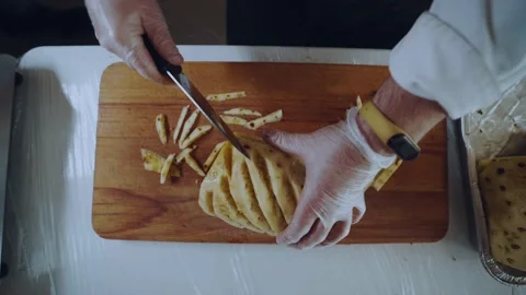 Preparation of pineapple with a knife in white gloves Video stock 167484380