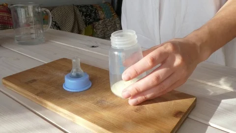 Preparation, preparing powdered milk in the bottle for the baby, infant Видео 72241464