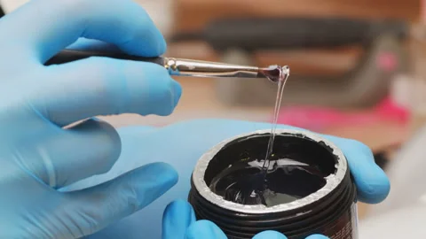The preparation process before applying shellac in a beauty salon.  Close-up. Video stock 155198765
