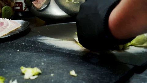 Preparation salad in professional kitchen cutting vegetables moving camera Video stock 129113799