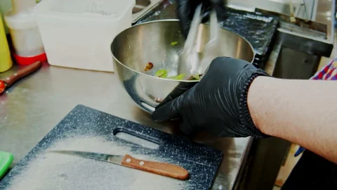 Preparation salad in a professional kitchen moving camera slow motion Video stock 129111142