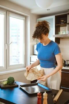 Preparation of smashed broccoli with cheese in a kitchen setting during dayti Stock Photos