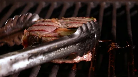 Preparation of steak on the grate and coals. Chef making steak. Video stock 131718247