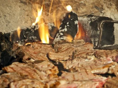 Preparation of steaks on grill Stock Photos