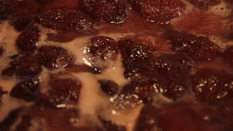 Preparation of strawberry jam. Cook jam. Homemade berry jam boils in a large Stock Footage 109330282